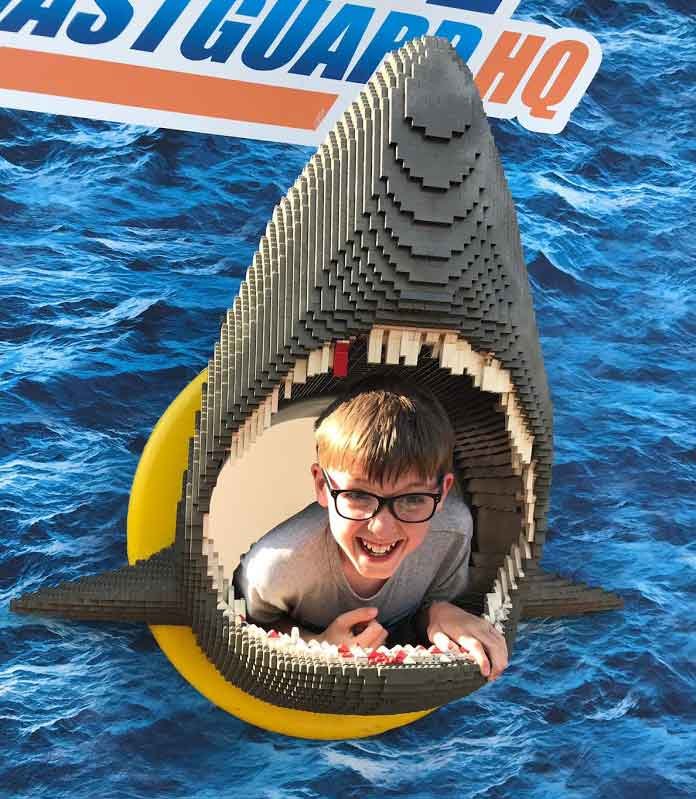 Fun at Legoland small boy in mouth of Lego shark at Legoland near Windsor, Berkshire, England