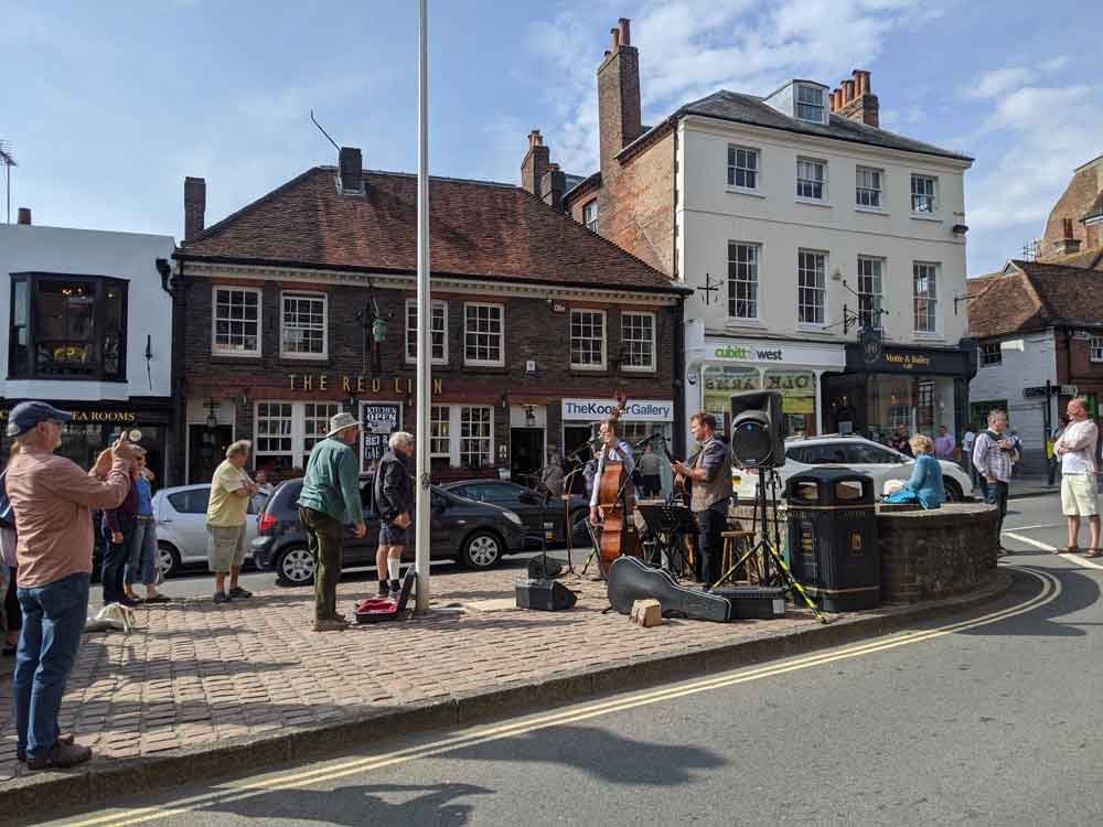 View of Arundel High Street with three piece band playing