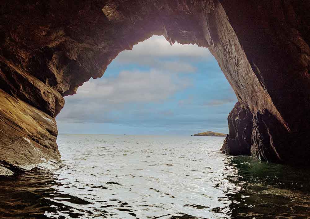 View from inside sea cave looking out onto open water