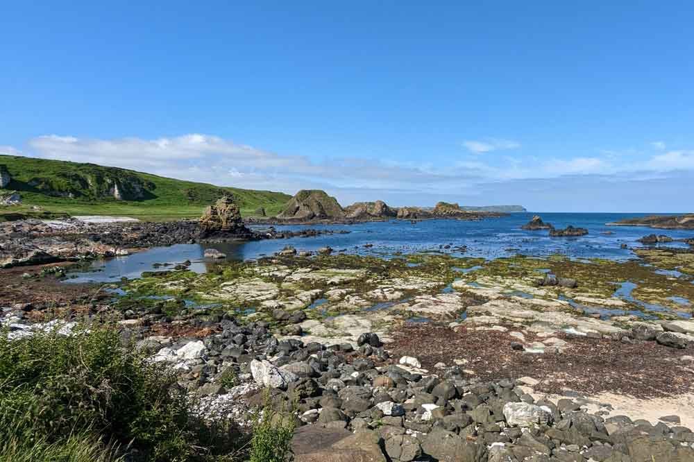 Blue skies, coastal views as seen Game of Thrones filming location, Ballintoy Harbour, Northern Ireland