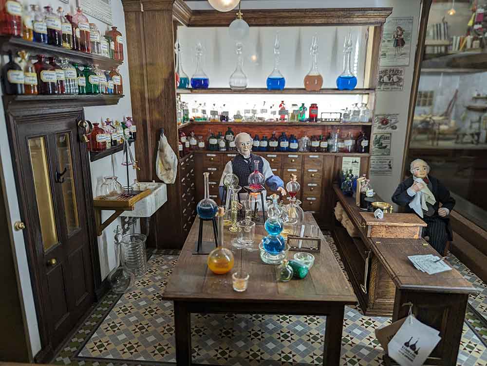 Image of miniature chemist shop inside dolls house