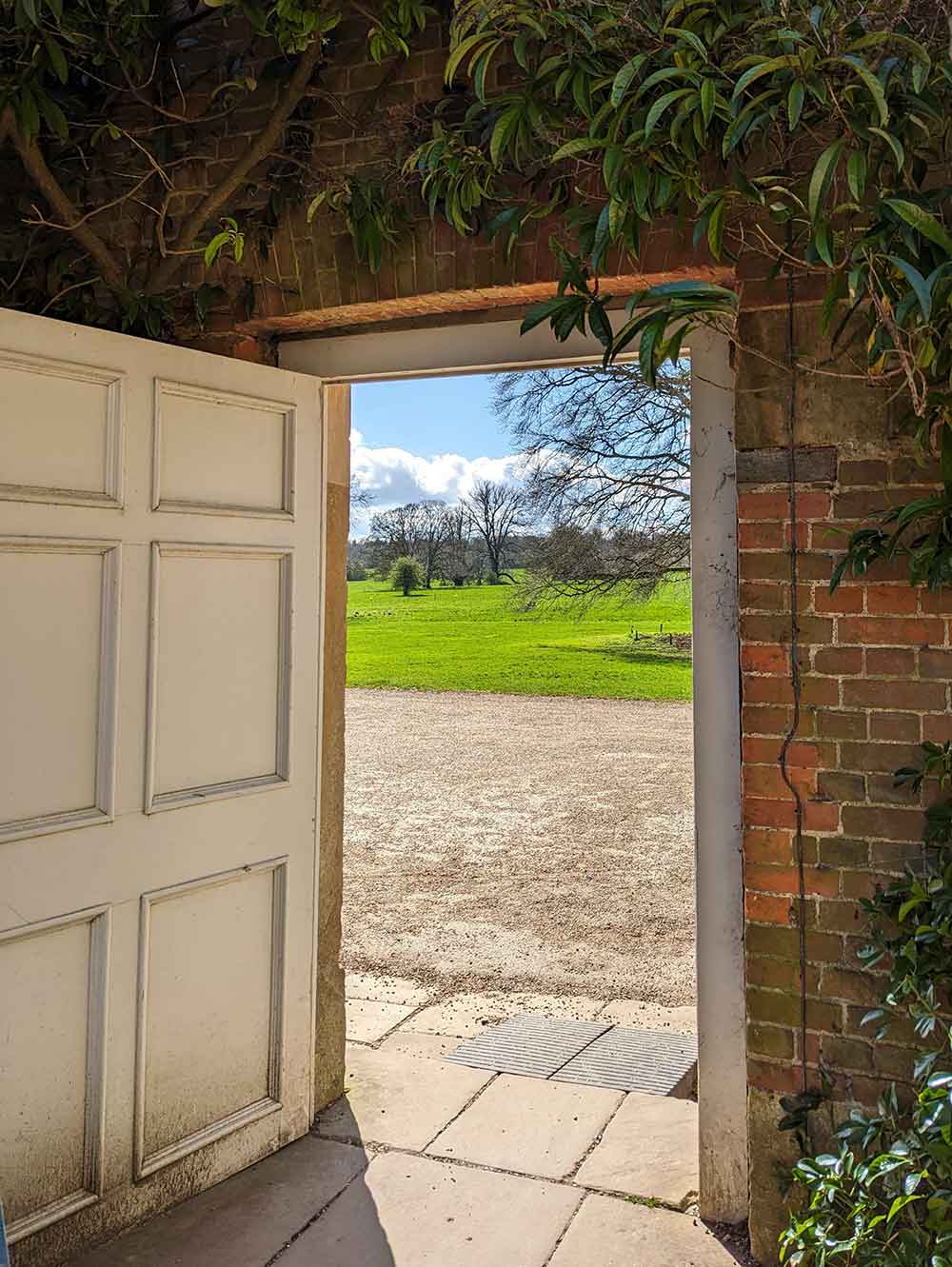 Open door looking out onto estate at Basildon Park