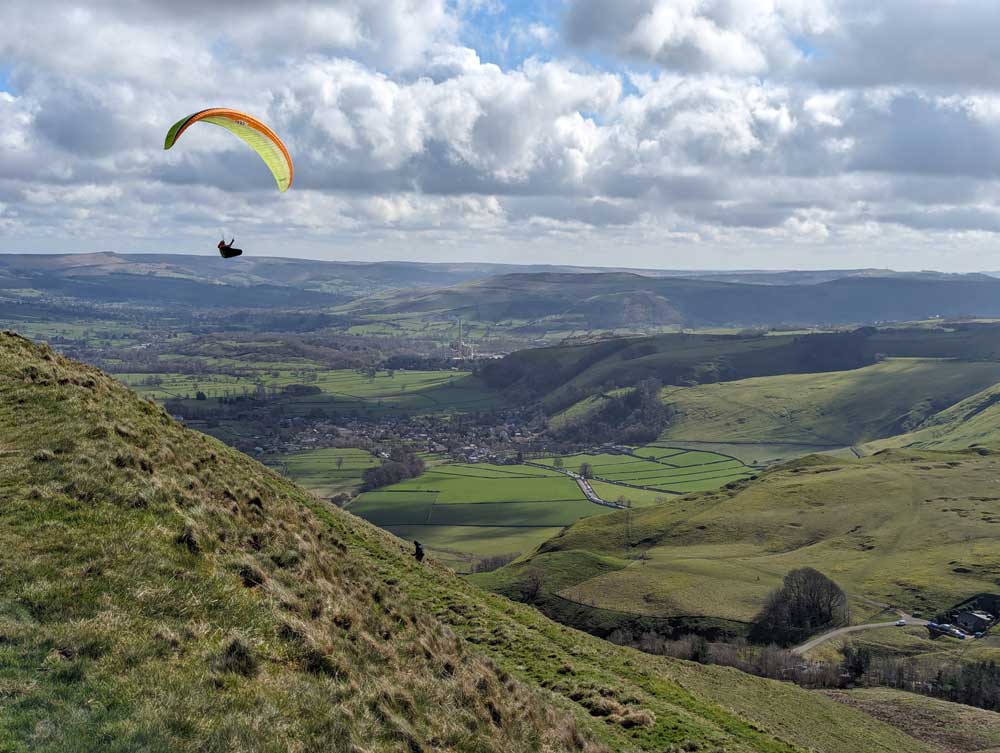 Paraglider flying alongside the Mam Tor, Derbyshire