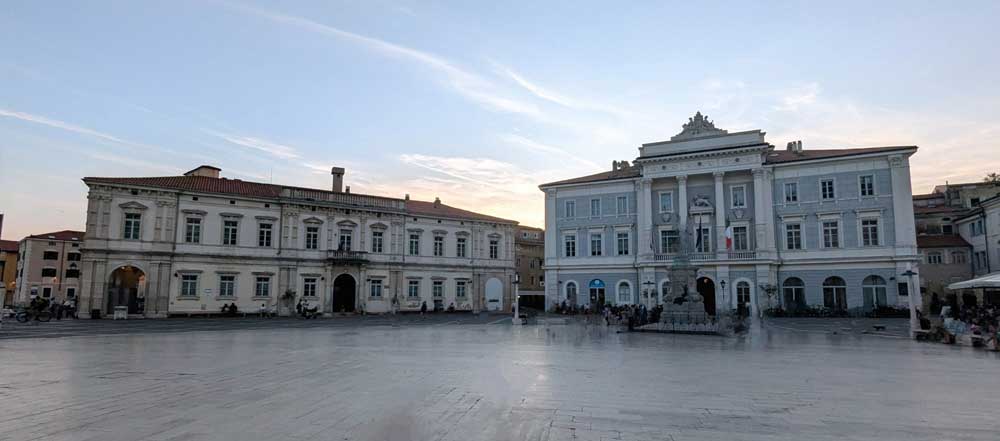 Two Venetian styled buildings and a statue in the historic Tartini Square, Piran Slovenia