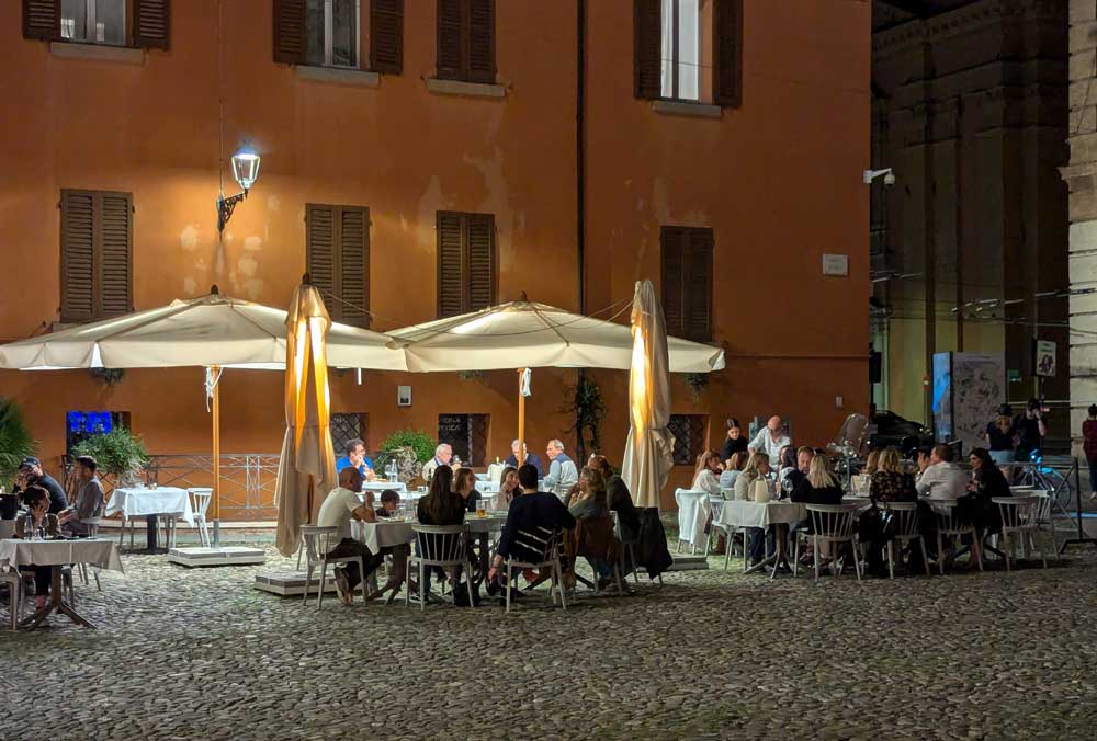 Dining outside at night in the Piazza Roma, Modena at nigh