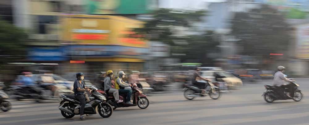 Mopeds driving past in Hanoi