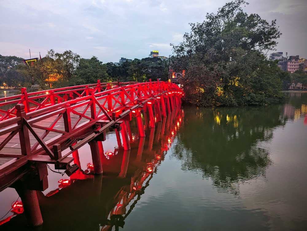 Red lit Bridge leading to Ngoc Son Temple, Vietnam