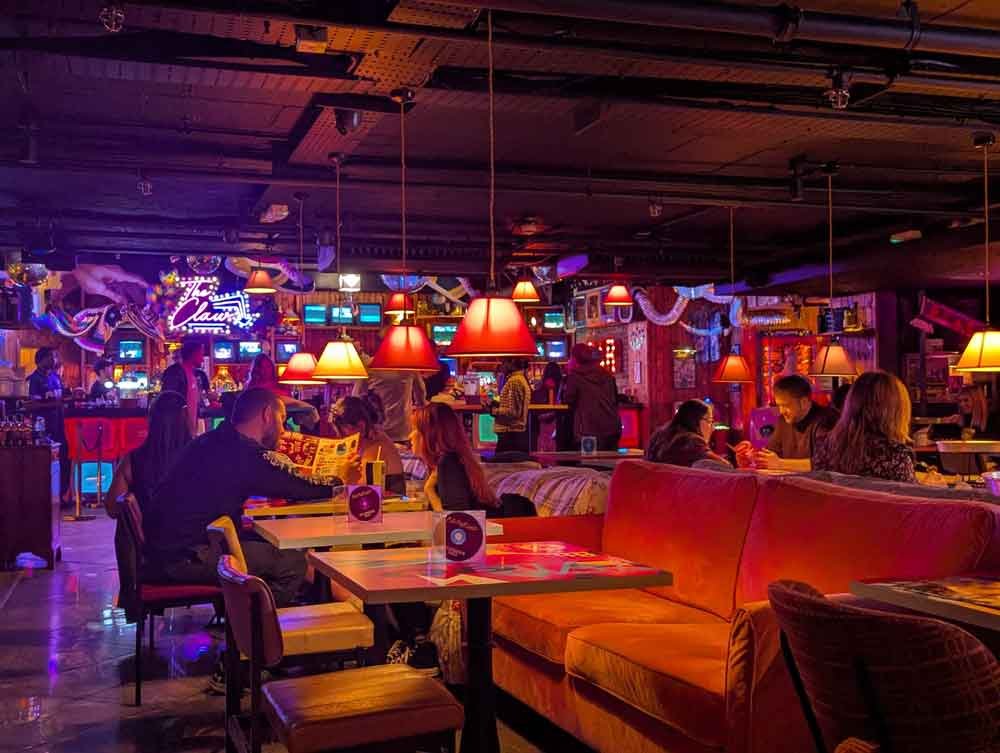 Bar at Bunga 90 Table and chair booths with low dark ceiling in the Bar at Bunga 90