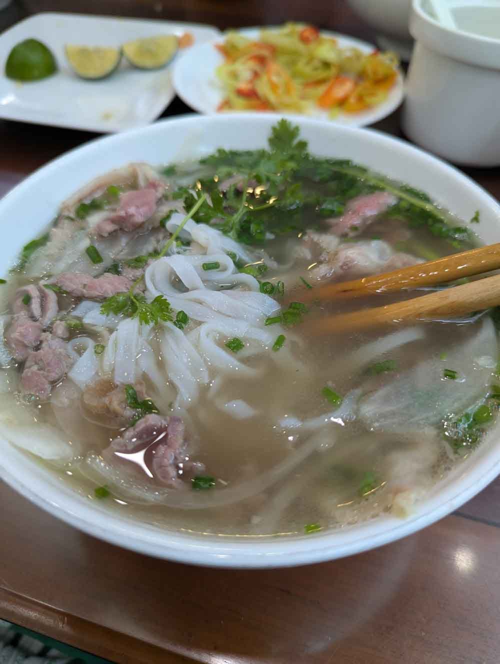 Bowl of Pho, mixture of noodles, pork, vegetables and broth, Vietnam
