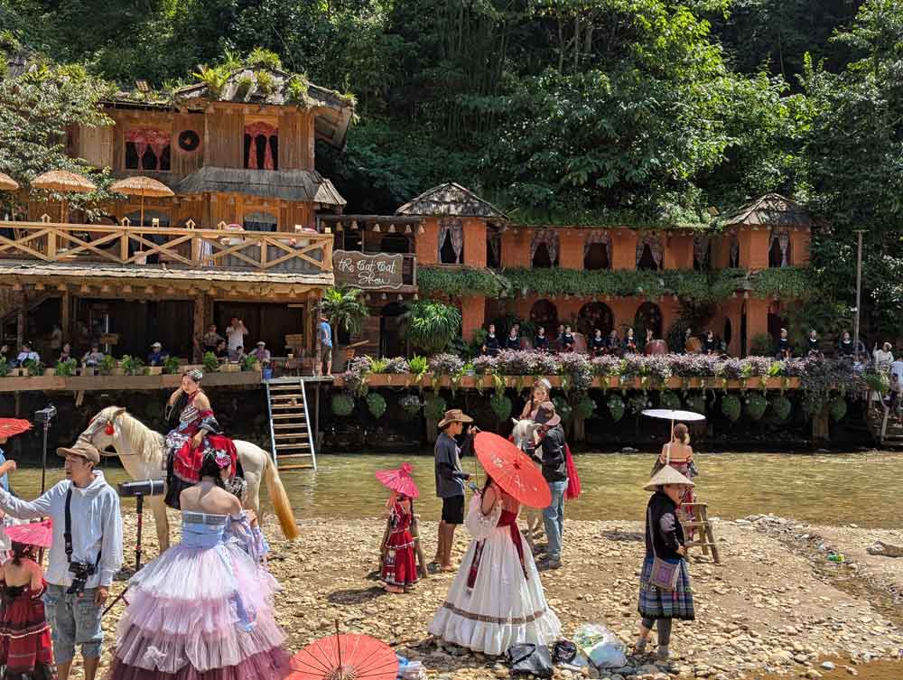 People dressed in traditional costumes by the river in Cat Cat Village, Sapa, Vietnam