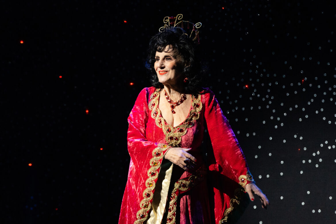 Queen Dragonella in red velvet gown and red necklace at Woking panto