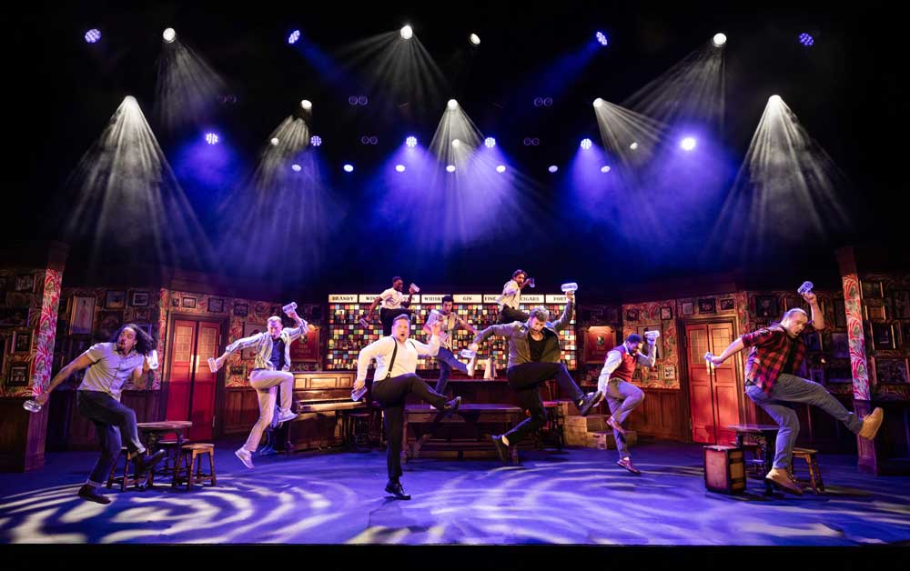 Cast of the Choir of Man Dancing on Stage