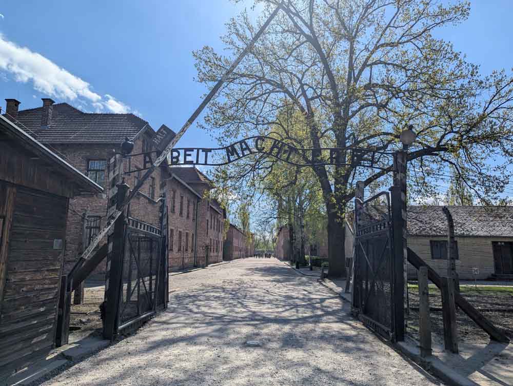 Gates with sign Arbeit macht Frei leading into Auschwitz concentration camp