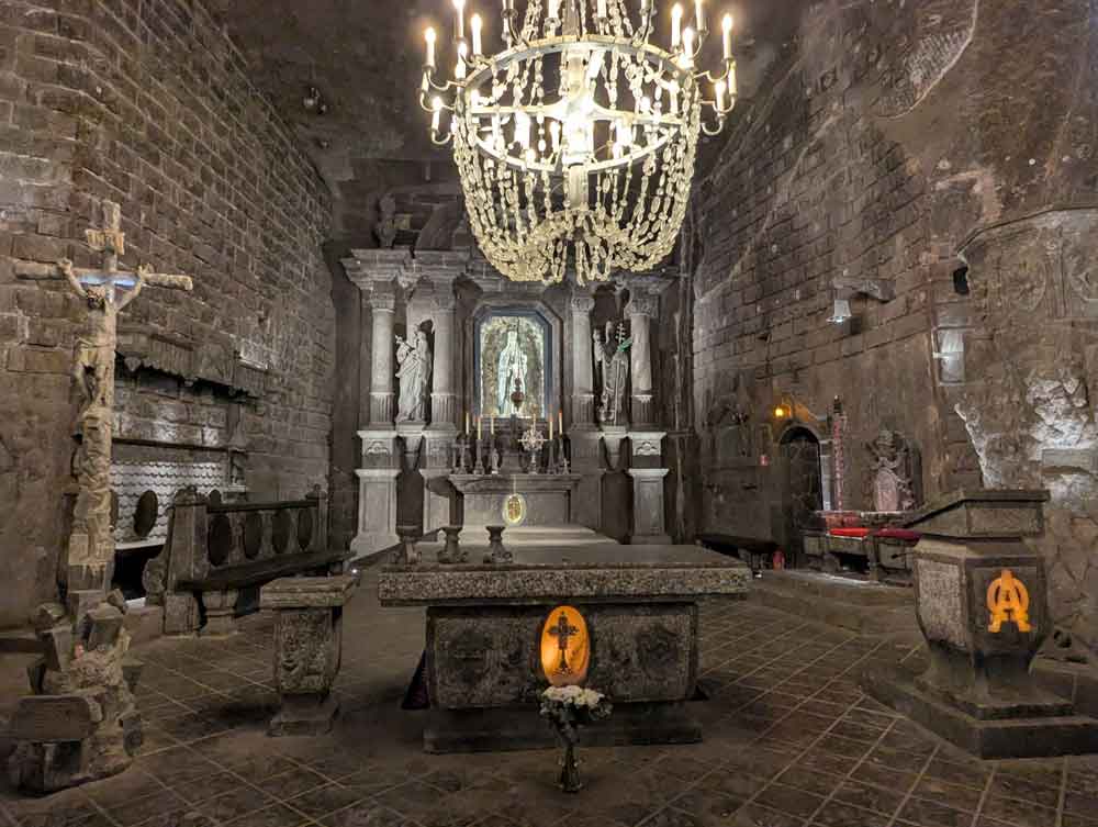 Underground chapel made from salt with large salt chandelier in foreground, at Wieliczka Salt Mine