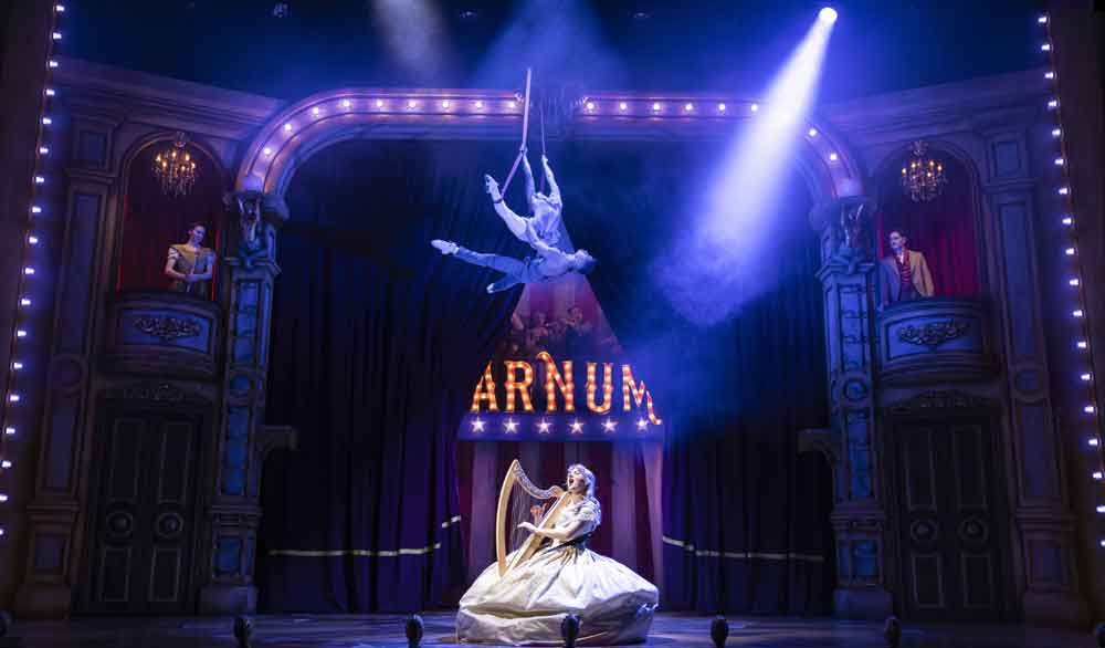 A singer and aerial artist performing in Barnum at Woking Theatre. Photo credit @ Pamela Raith