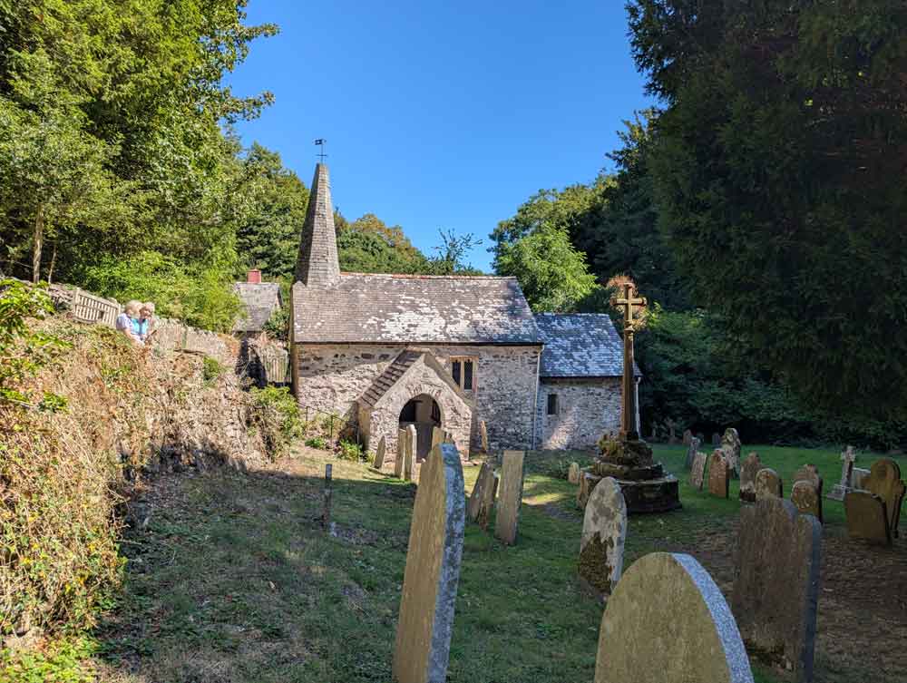 Tiny church (Culbone Church) with graveyard in foreground
