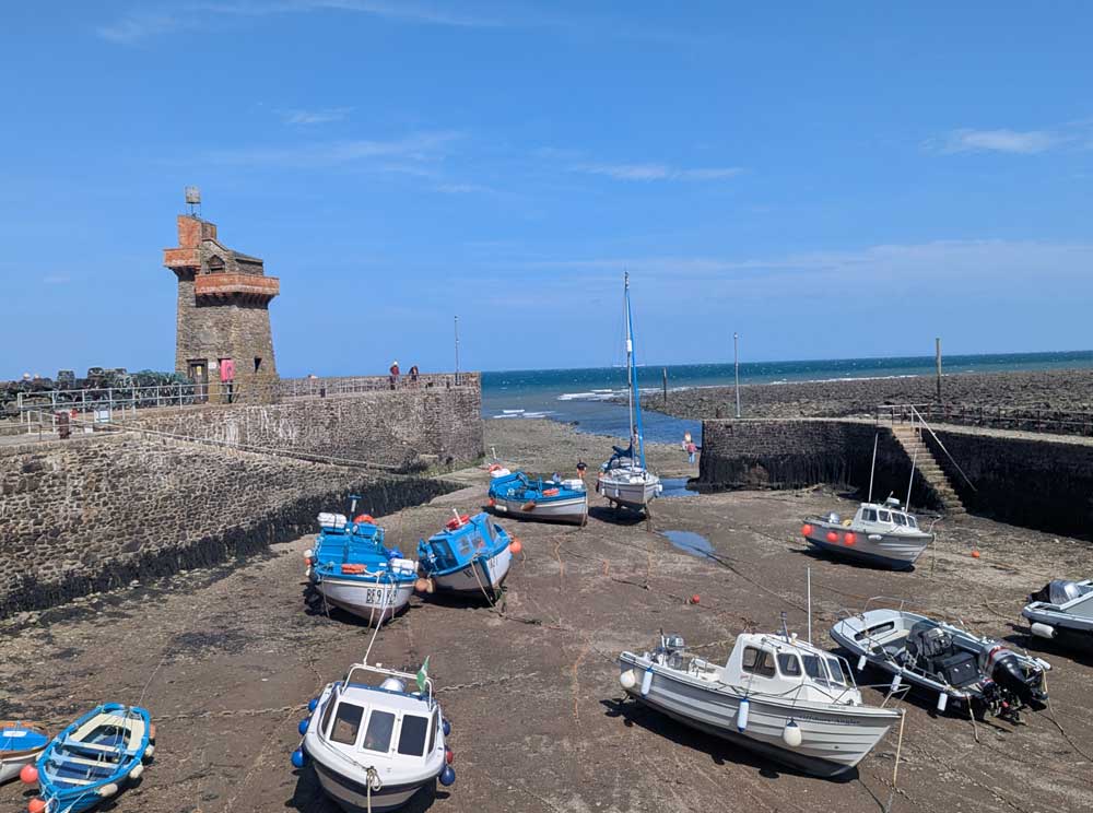 boats resting on sea bed of Lynmouth Harbour as tide is out