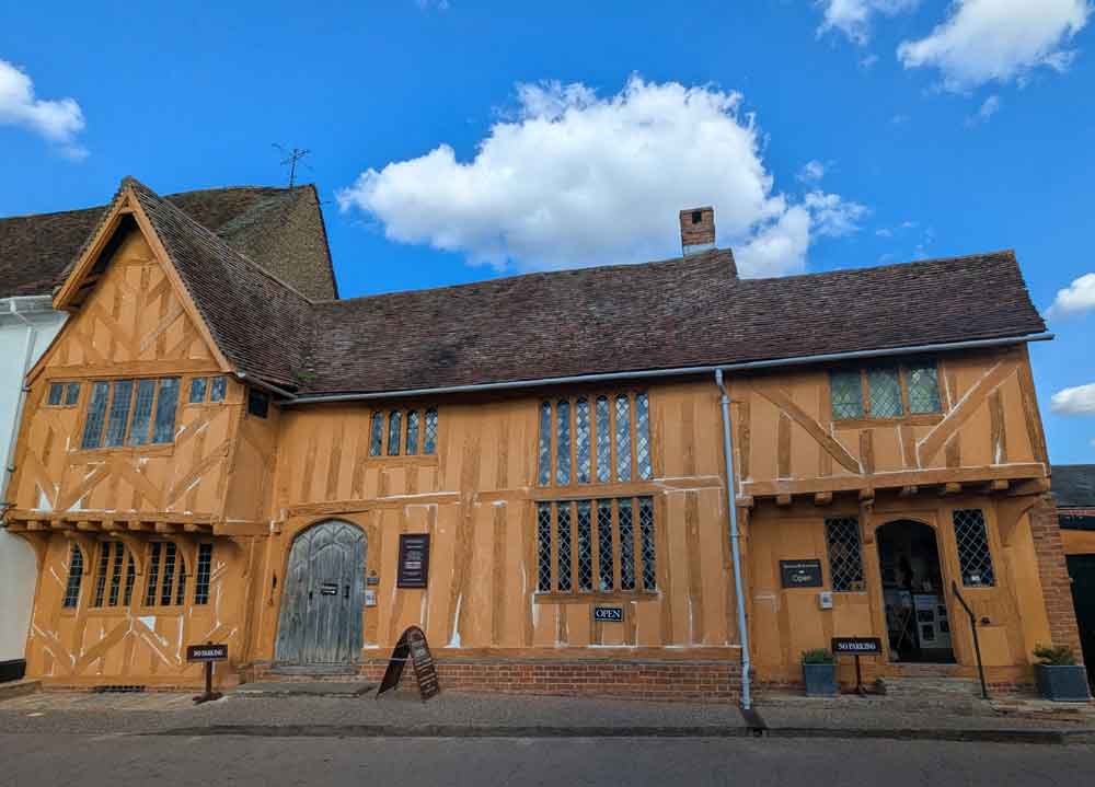 ochre-yellow timber-framed house called Little Hall in Lavenham