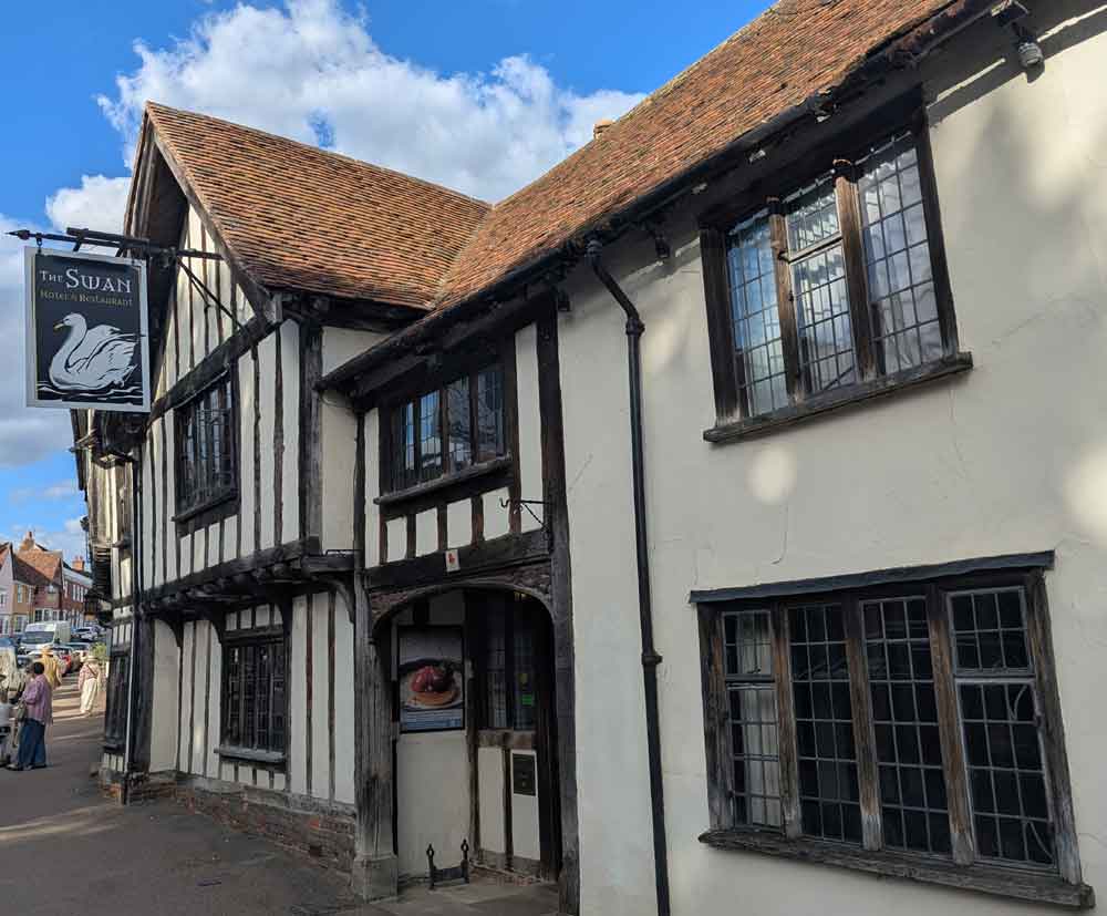 Timber-framed white building with The Swan sign outside